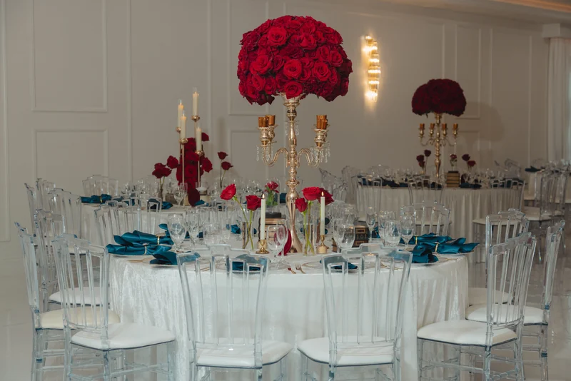 Reception tables set with red roses in the Grand Ballroom